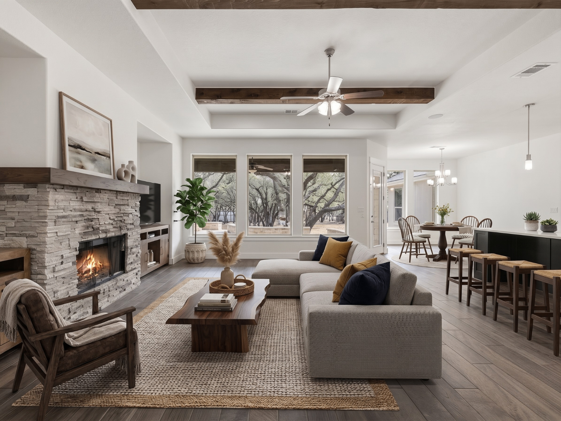 Living room interior at 137 Chickasaw Plum Drive with stone fireplace and Hill Country views